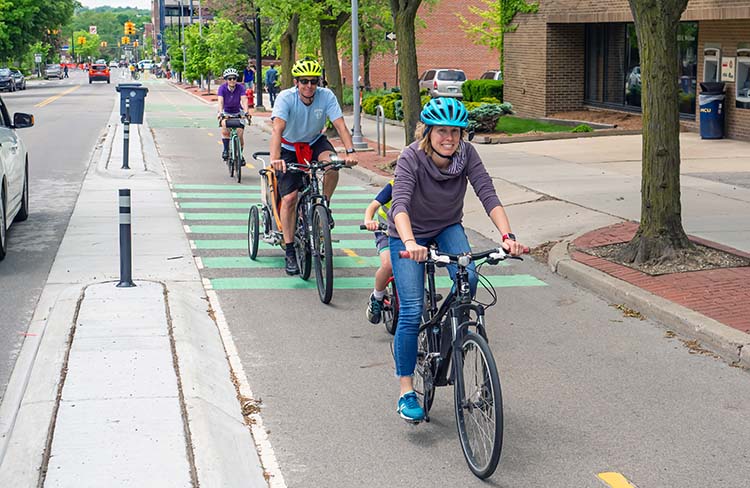People biking William Street Bikeway