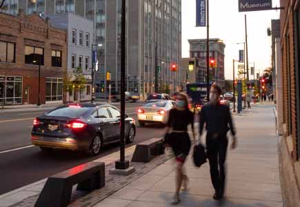 Two walkers at dusk on Huron Street, Ann Arbor